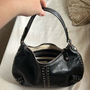 MICHAEL Michael Kors. Black leather shoulder bag with silver studs.